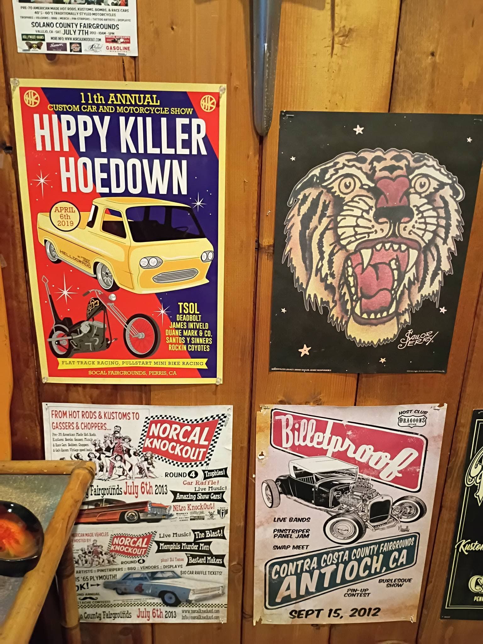 Framed vintage motorcycle and hot rod event posters