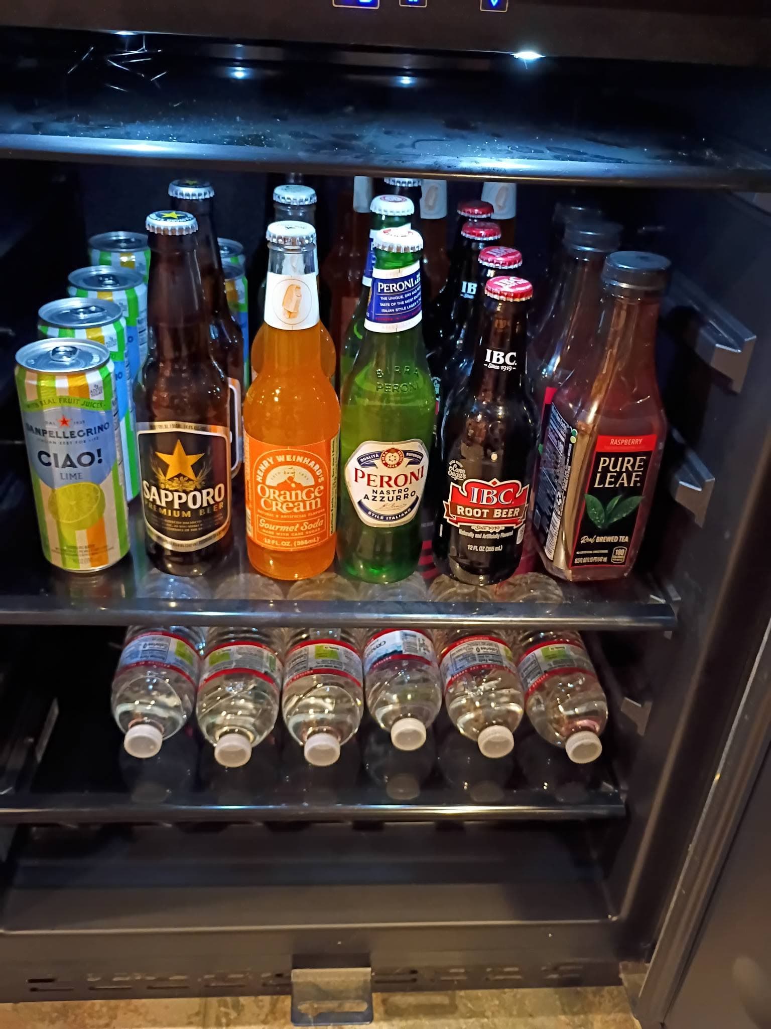 Refrigerator display with beer bottles and shot glasses