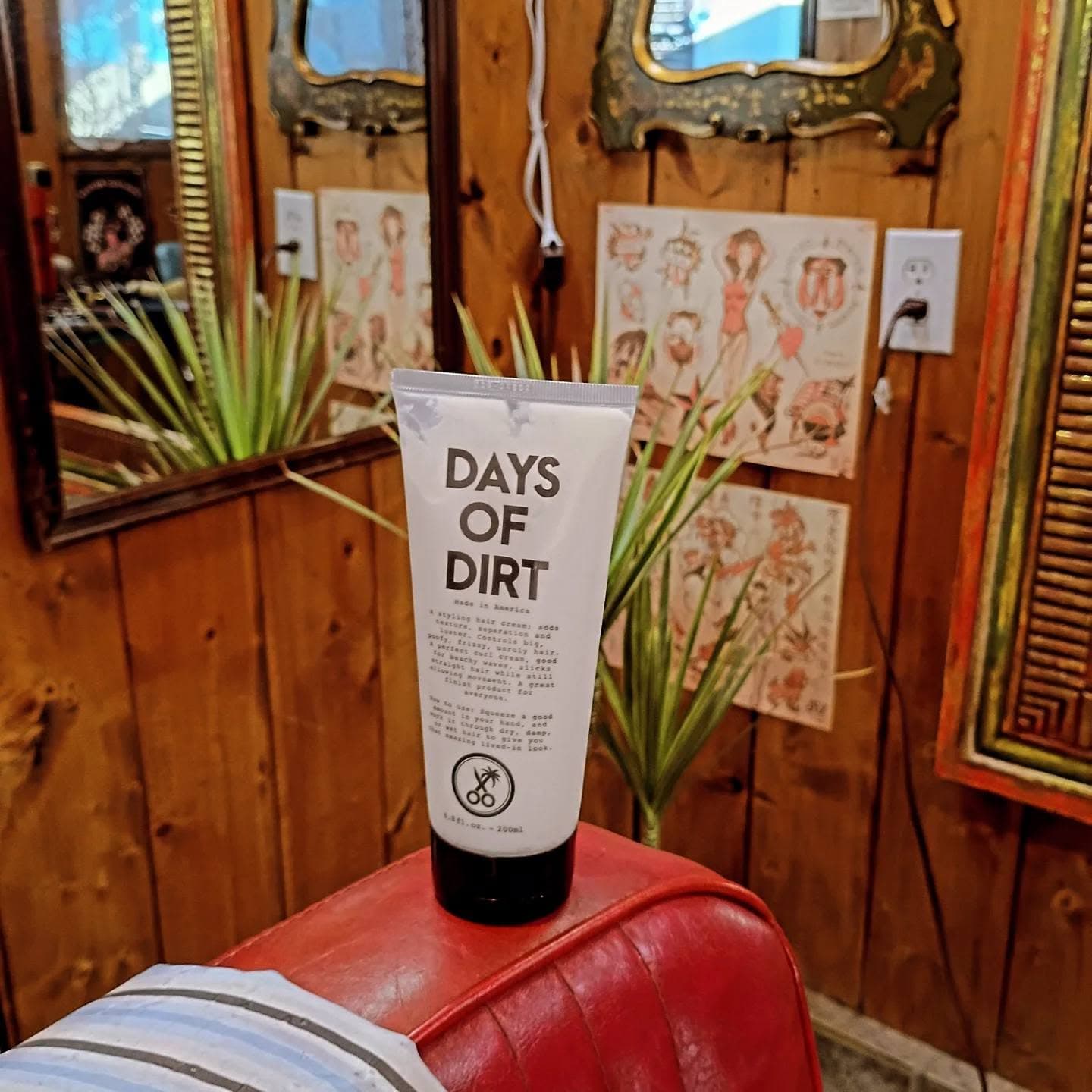 Barbershop interior with wooden walls and hair product on red chair